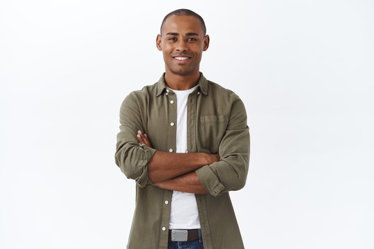 Business, people and lifestyle concept. Portrait of handsome african american man cross hands on chest and smiling pleased, own small shop, manage store with help of employees, white background