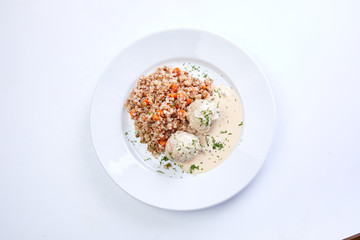 meatballs with buckwheat and sauce on the white