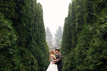 groom in military uniform and bride in wedding dress with shawl