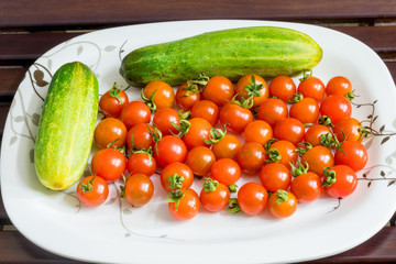 Red min tomatoes with green cucumber