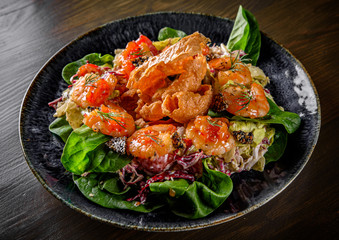 Fresh salad plate with shrimp, tomato, spinach, cabbage and Tangerine Jam in plate on wooden table background