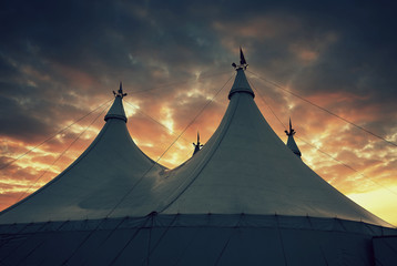 Detail of circus tent with colorful cloudy sky © Zsolt Biczó