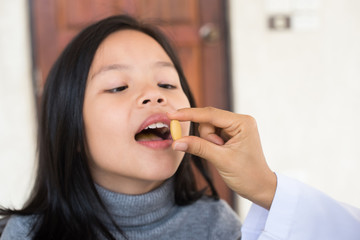 cute little girl having sick and happy to taking medicine in mouth. .Kid having pharmaceutical...