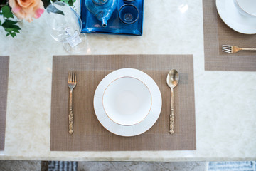 Dishes and the silverware on the dining table 