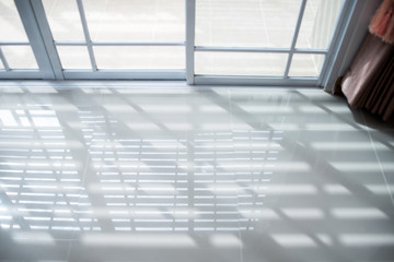 Sliding glass doors with sunlight reflecting the floor