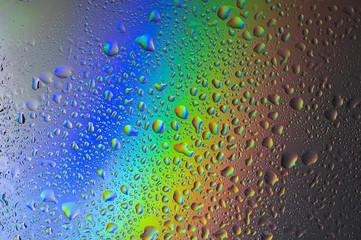 Background splash with drops on glass. Colorful background and drops of water.