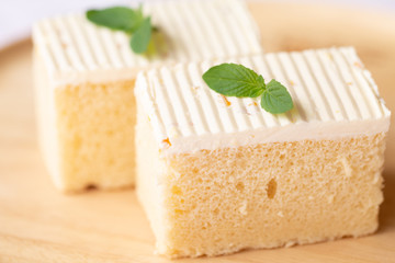 Sliced of cheesecake with mint leaves decorated on top.