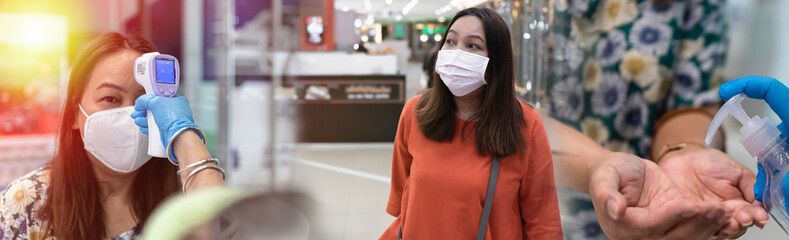 CORONAVIRUS COVID-19 virus concept, Shopper woman with face mask, thermoscan infrared, hand sanitize spray at shopping mall center.