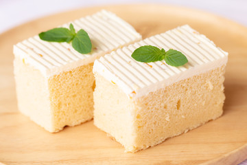 Sliced of cheesecake with mint leaves decorated on top.