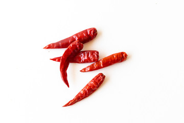 Dried pepper chillies on white background