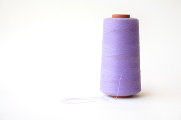 The coil with purple threads on White background.