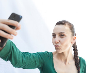 young girl with braid taking a selfie