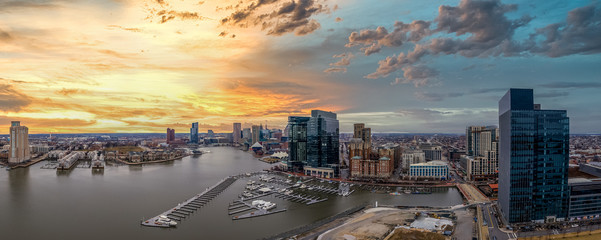 Aerial view of colorful, yellow, orange, red, blue sunset sky of the Inner Harbor of Baltimore...
