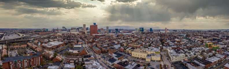 Aerial view with dramatic sky of various downtown Baltimore Maryland neighborhoods USA