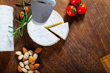 Camembert cheese or brie on wood background