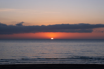 The sun rising above the sea at dawn
