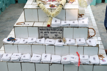 Religious objects are waiting for a blessing on the grave of Croatian missionaries, Jesuit father...