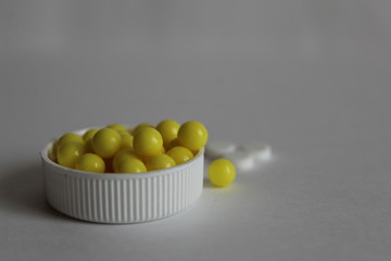 vitamins and tablets in a white cover on a white black background