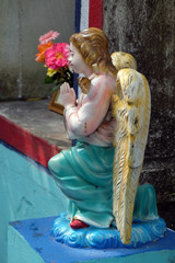 Fototapeta premium Angel at the Tomb of the Croatian Jesuit Missionary Ante Gabric Behind the Catholic Church in Kumrokhali, West Bengal, India