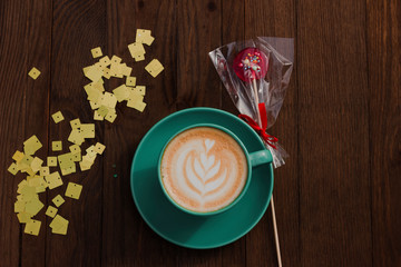 Layout with coffee and lollipops . Cappuccino. Flower drawn on coffee. Flat lay