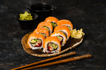 Roll sushi with salmon, cucumber, avocado, cream cheese, red caviar. Sushi menu. Japanese food.