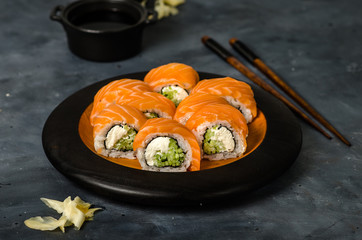 Philadelphia roll sushi with salmon, smoked eel, cucumber, avocado, cream cheese, red caviar. Sushi menu. Japanese food.