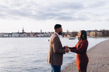 Fototapeta premium Loving happy couple hugging outdoors together. Dating and romance time for loving people. Proposal concept