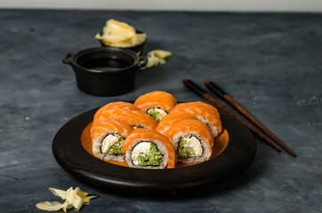 Philadelphia roll sushi with salmon, smoked eel, cucumber, avocado, cream cheese, red caviar. Sushi menu. Japanese food.