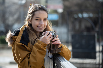 Photo of young tourist girl exploring streets of Baku. Moody photos of teenager girl visiting old city and taking photos of the city