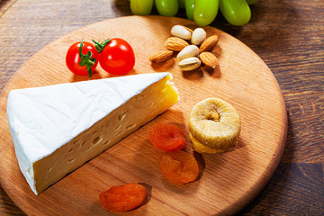 Camembert cheese or brie on wooden background