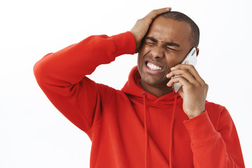Close-up portrait of bothered young grimacing african-american man forgot about date, punch head...
