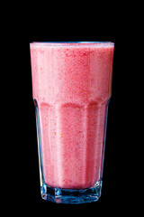 Lilac berry smoothie in a large glass glass on a black background, isolated.