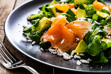 Salmon salad - smoked salmon white rice and vegetables on wooden table
