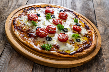 Margherita pizza on wooden background