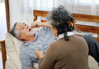 Elderly couple lover care and concern In a sick time at home.