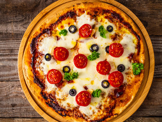 Margherita pizza on wooden background