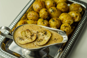 Mini jacket potatoes with mushrooms sauce on the silver tray