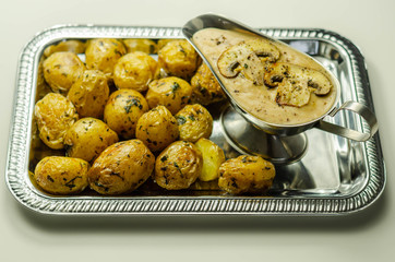 Mini jacket potatoes with mushrooms sauce on the silver tray