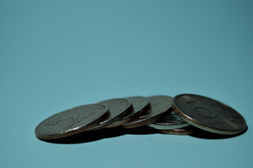 a hill of iron coins on a mint background