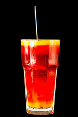 Red berry smoothie in a large glass glass on a black background, isolated