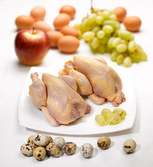 raw chicken eggs and fruits on the kitchen table