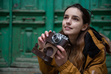 Photo of young tourist girl exploring streets of Baku. Moody photos of teenager girl visiting old city and taking photos of the city