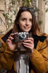 Photo of young tourist girl exploring streets of Baku. Moody photos of teenager girl visiting old city and taking photos of the city