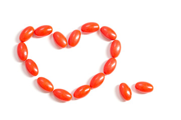 red pills in form heart isolated  on white background