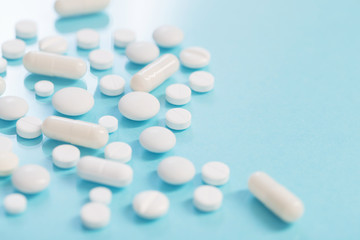 white pills on  blue background