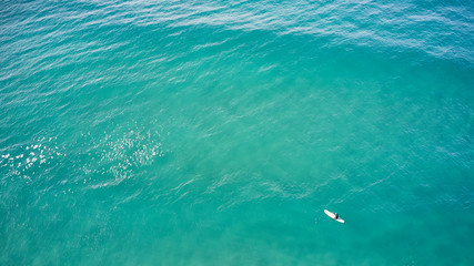 longboarder waiting in blue water