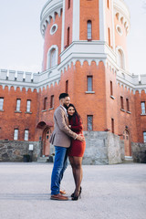 Loving happy couple hugging outdoors in city streets together. Dating and romance time for loving people