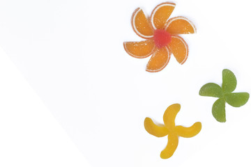 Fototapeta premium Multi-colored slices of fruit marmalade laid in the form of flowers