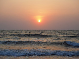 beautiful sunset on the background of the sea and the beach