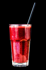 Red berry smoothie in a large glass glass on a black background, isolated